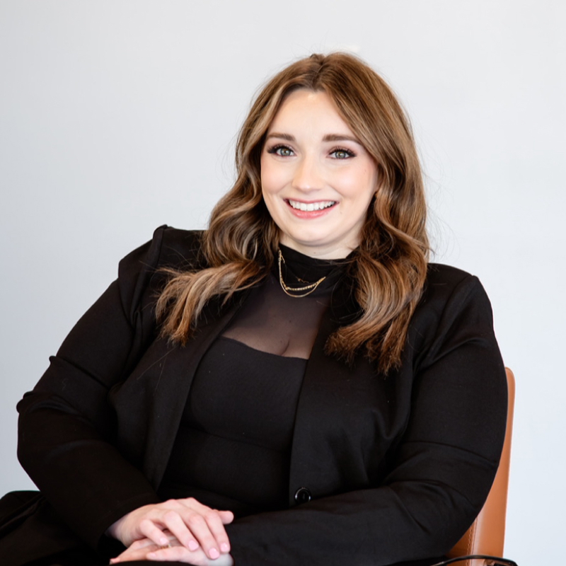 Kyla Koepke, owner of K.A. & Co. Salon in Beresford, sitting confidently in her salon