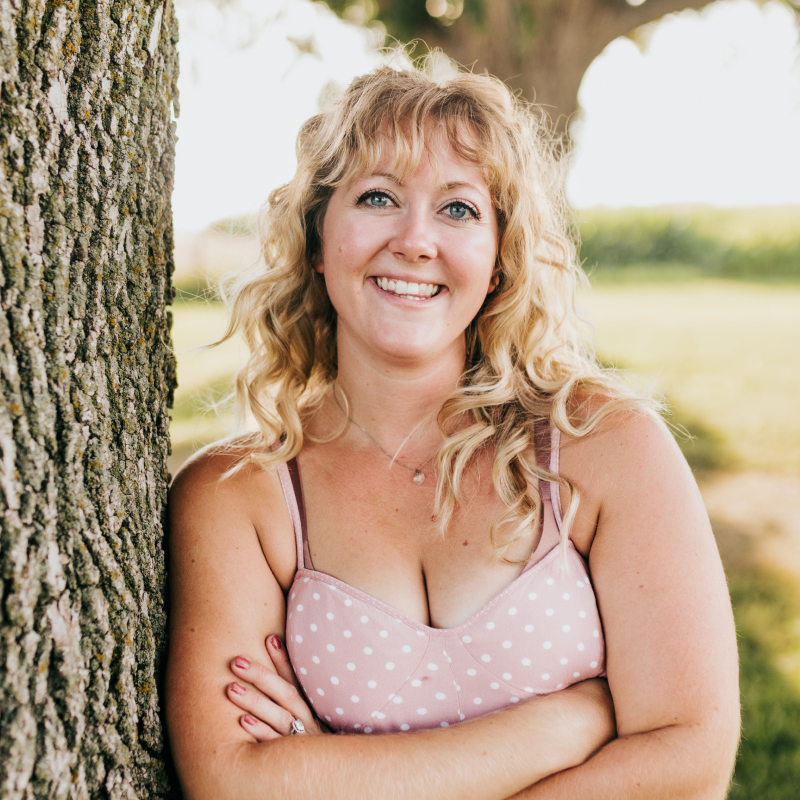 Shania Rozeboom, owner of Rainy Day Coffee Co., standing outdoors with a smile